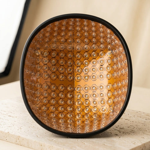 The removable dome insert of the Luxuel Laser Cap 272, its amber board densely filled with round lensed laser emitters across the full oval